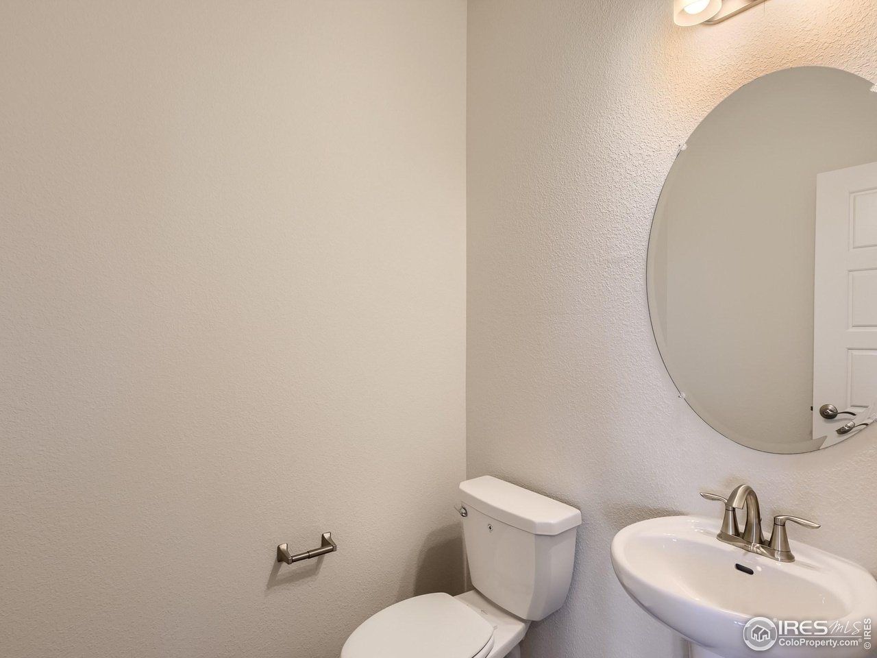 2538 Doe Rdg Way Johnstown, CO 80534 - Photo 14 of 28 a bathroom with a toilet a sink and mirror