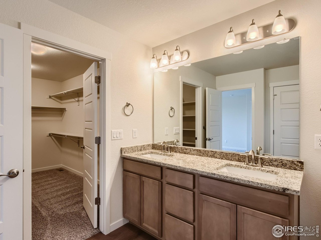 2538 Doe Rdg Way Johnstown, CO 80534 - Photo 17 of 28 a spacious bathroom with a granite countertop sink and a mirror