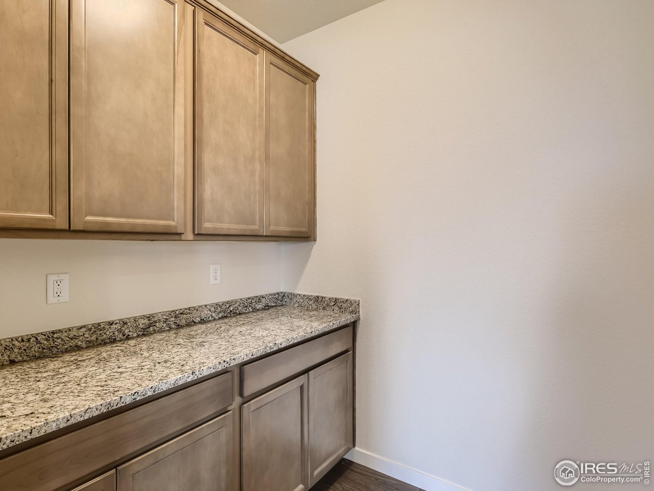 2538 Doe Rdg Way Johnstown, CO 80534 - Photo 26 of 28 a kitchen with granite countertop white cabinets and white stainless steel appliances