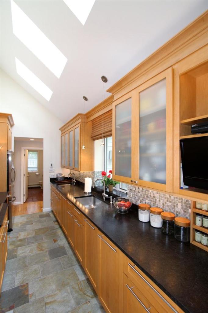 208 Tonset Road Orleans, MA 02653 - Photo 5 of 27 a kitchen with stainless steel appliances granite countertop a sink and a counter top space