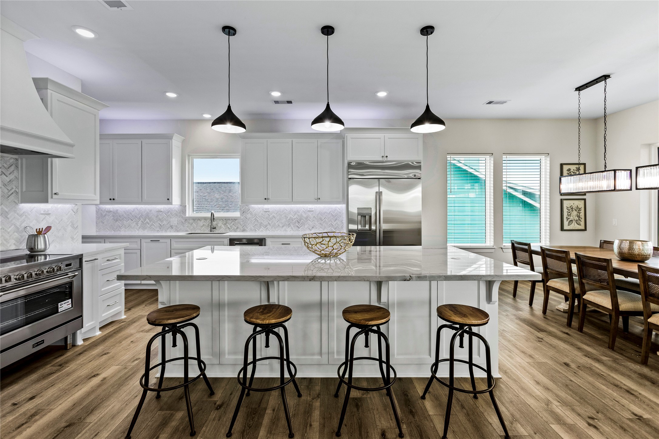 1986 Patton Beach Road Crystal Beach, TX 77650 - Photo 8 of 45 a kitchen with stainless steel appliances granite countertop a kitchen island a table and chairs in it