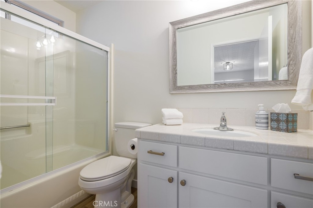 2091 Circle Drive Cayucos, CA 93430 - Photo 14 of 21 a bathroom with a granite countertop sink toilet and mirror