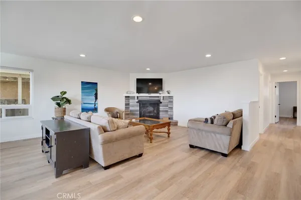 a living room with fireplace furniture and a wooden floor