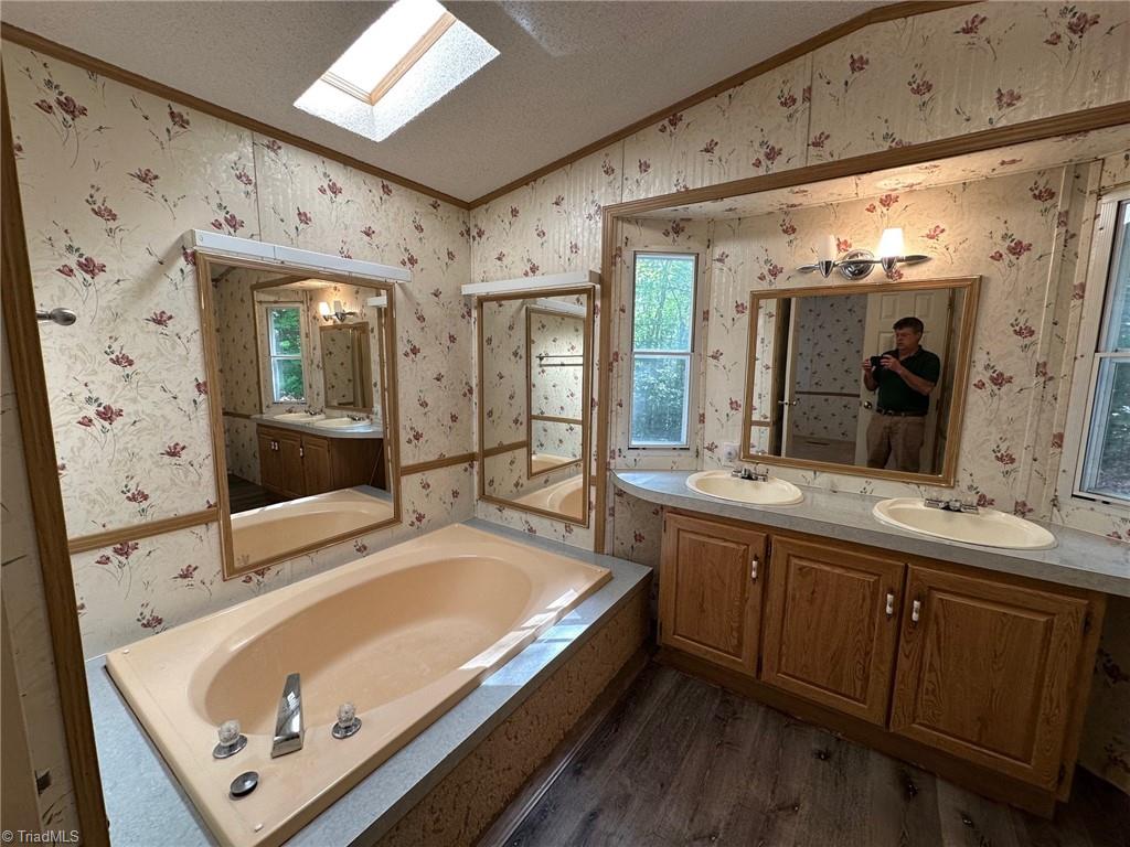 249 Laurel Bluff Trail Dobson, NC 27017 - Photo 17 of 25 Primary bath with tub and shower.