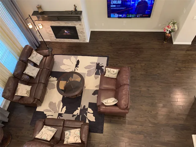 a living room with chairs and a fireplace