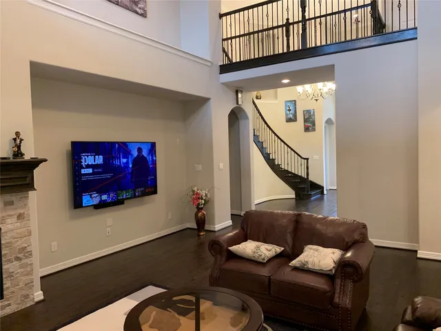 a living room with furniture and stairs
