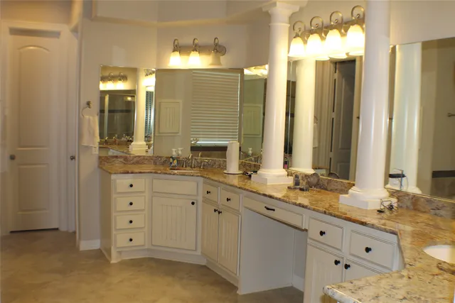 a bathroom with a double vanity sink and a mirror