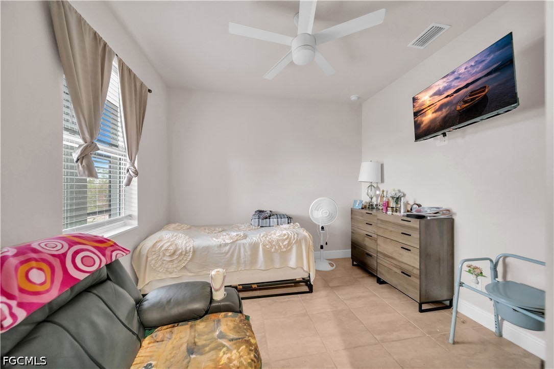 384 Neighborly Road LaBelle, FL 33935 - Photo 20 of 45 a bedroom with a bed and a tv