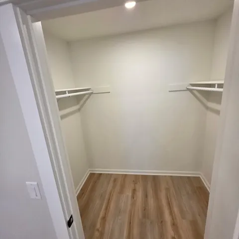 a bathroom with a granite countertop toilet a sink and a shower