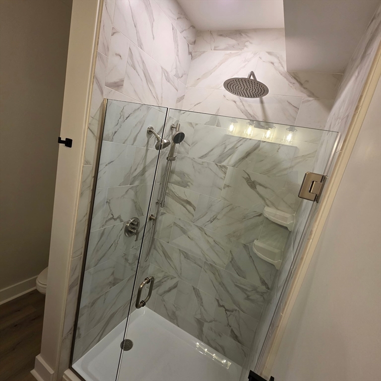 843 Main Street, Unit 107 Clinton, MA 01510 - Photo 8 of 12 a bathroom with a shower