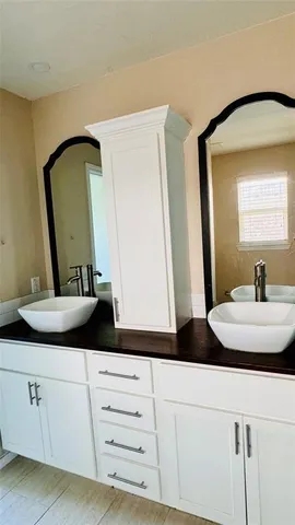 a bathroom with sink and mirror