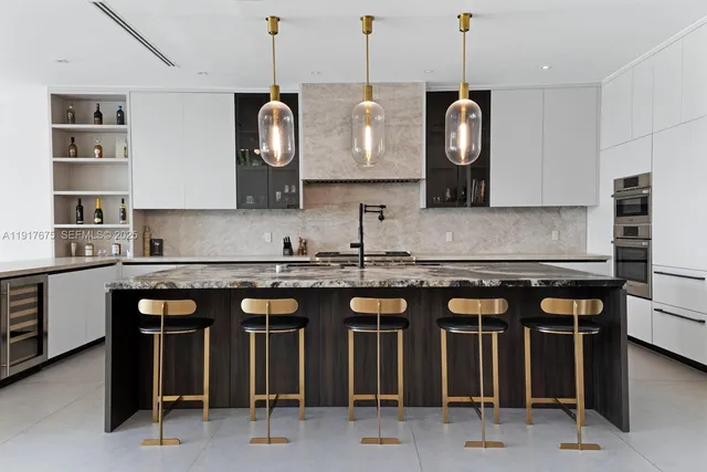 a kitchen with granite countertop a sink stove and refrigerator