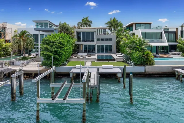 a living room with furniture and large windows