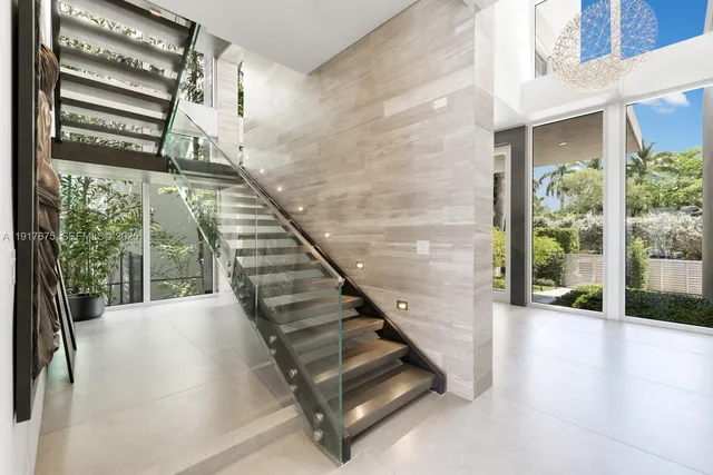 a view of a livingroom with wooden floor and a refrigerator
