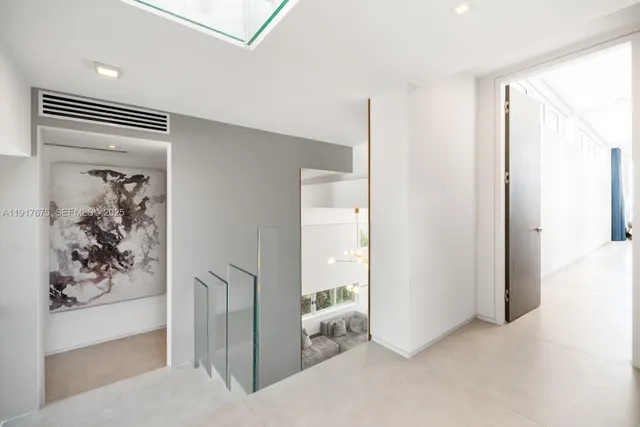 a bedroom with a bed and large windows