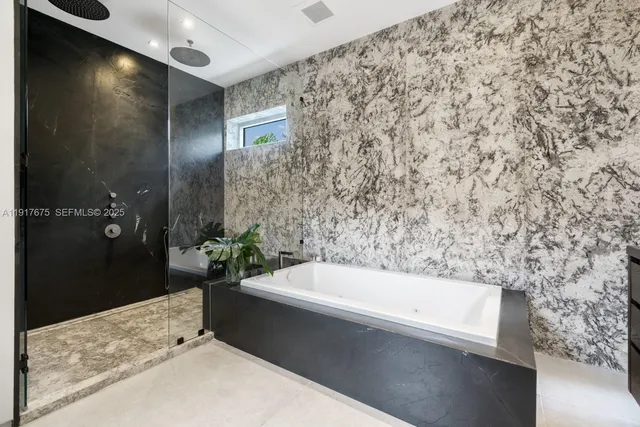 a bathroom with a granite countertop sink a toilet a mirror and shower