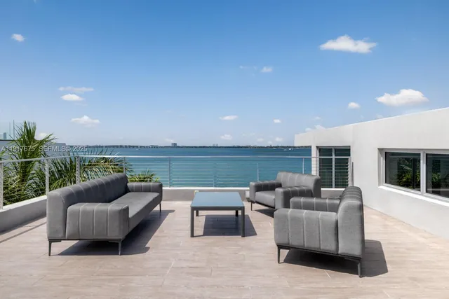 a spacious bedroom with a large bed and a potted plant