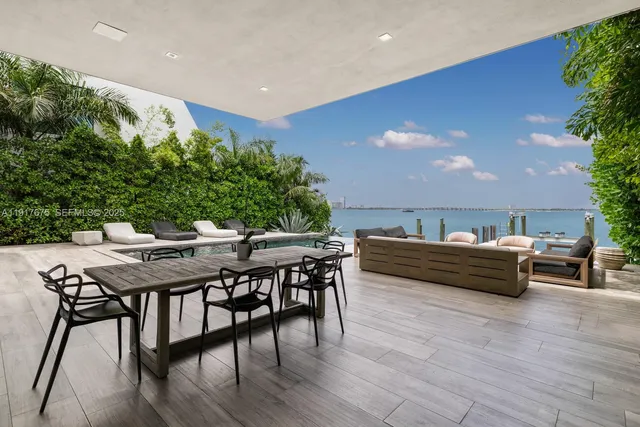 an aerial view of a house with outdoor space and lake view in back