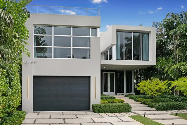 a view of a house with potted plants