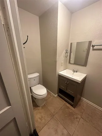a bathroom with a toilet a sink and a mirror