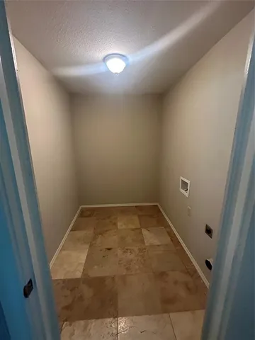 an empty room with a wooden door