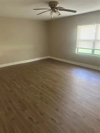 a view of wooden floor and windows in a room