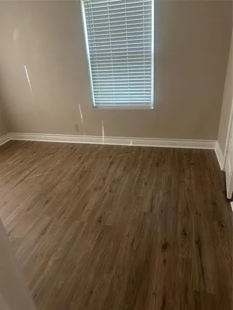 a kitchen with a wooden floor and white appliances