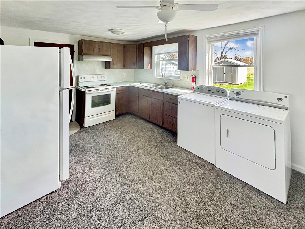 8411 Pitsburg-Laura Road Arcanum, OH 45304 - Photo 6 of 16 This functional kitchen features ample cabinetry and a convenient laundry area.