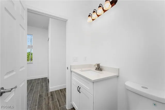 a bathroom with a sink toilet and vanity