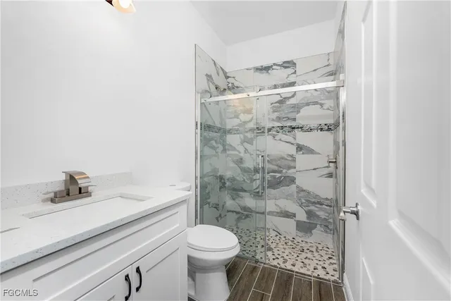 a bathroom with a sink toilet and shower