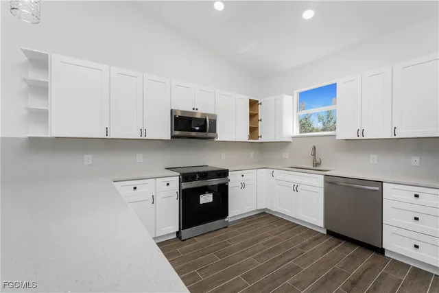 a kitchen with stainless steel appliances granite countertop a sink and cabinets