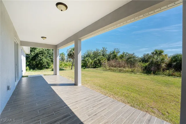 a view of a room with wooden floor and outdoor space