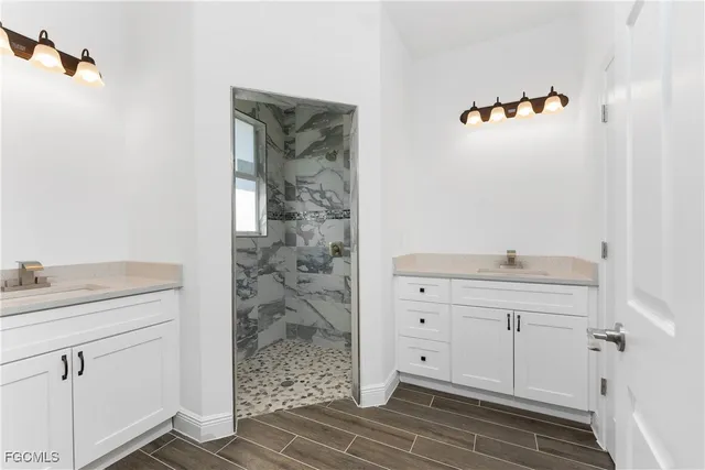 a bathroom with a shower sink and mirror