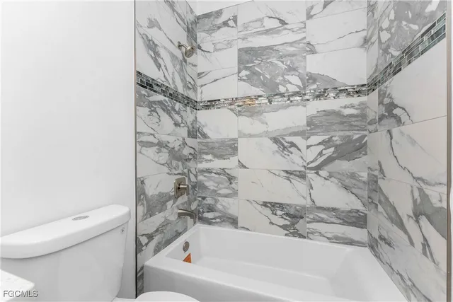 a bathroom with a bathtub and a toilet