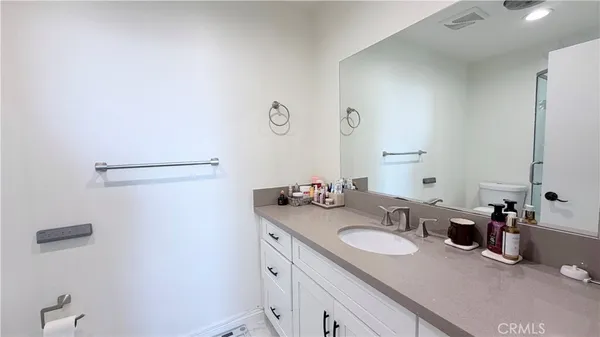 a bathroom with a granite countertop sink and a mirror