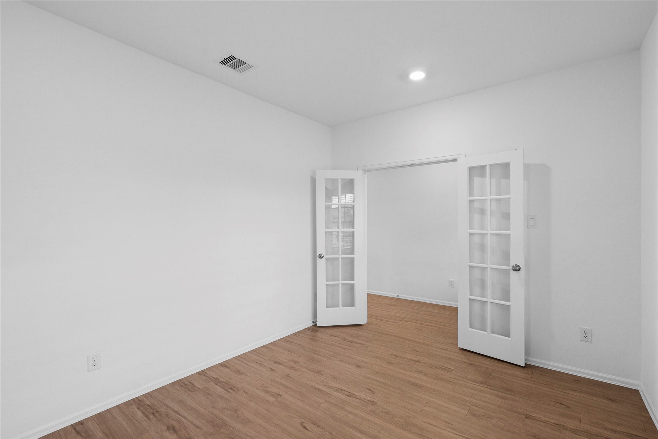 3705 Paloma Fls Lane Rosenberg, TX 77469 - Photo 13 of 27 Another angle of room Glass-panel French doors open to the adjacent space, with recessed lighting overhead.