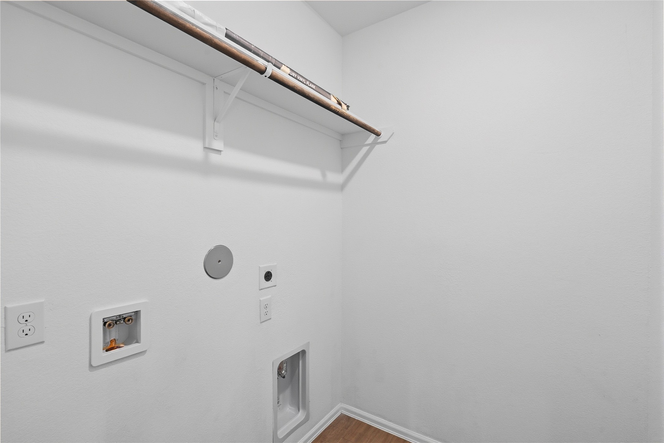 3705 Paloma Fls Lane Rosenberg, TX 77469 - Photo 14 of 27 Dedicated utility space with washer/dryer hookups and a wall-mounted storage shelf. Clean finishes and keep the area bright and tidy.