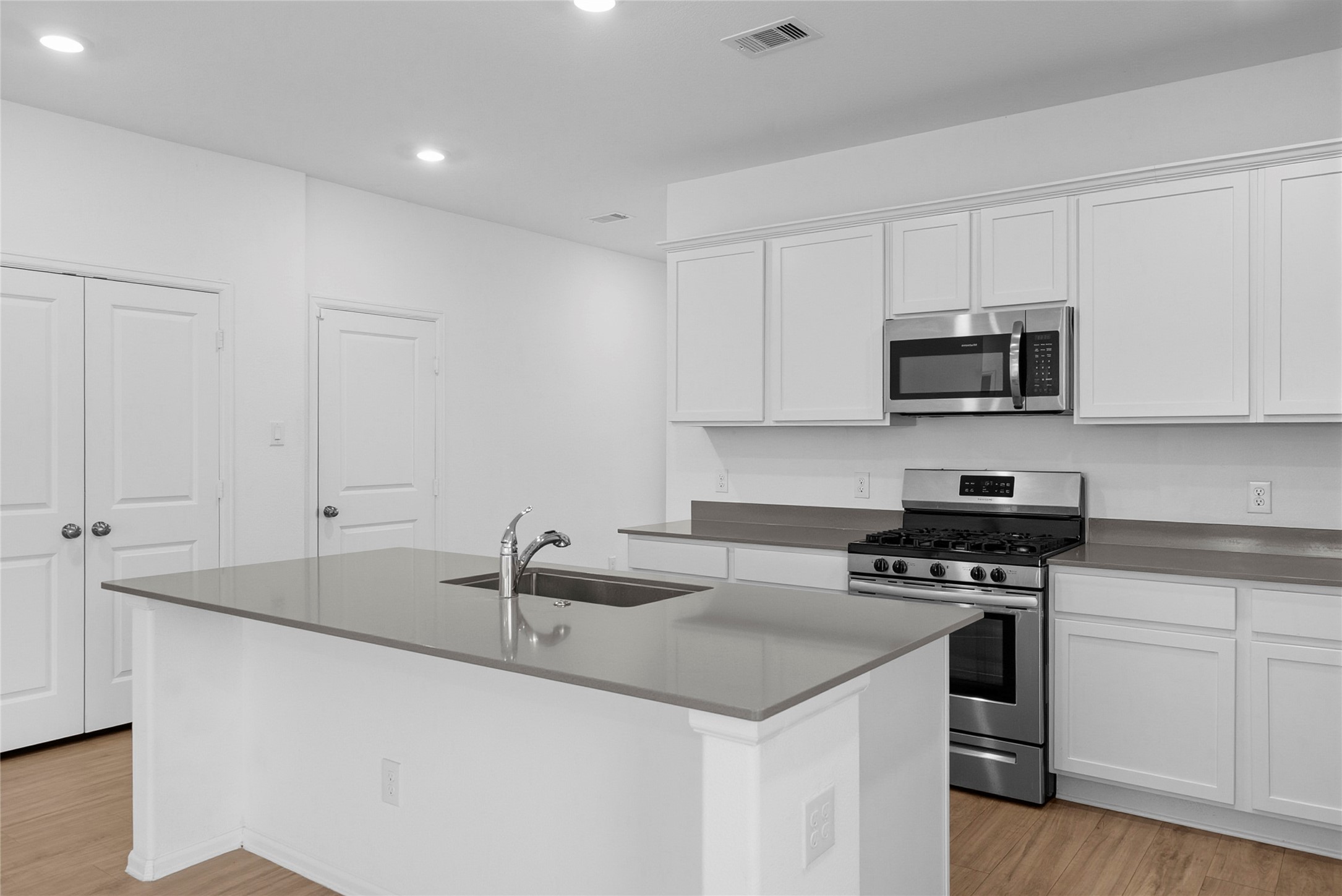 3705 Paloma Fls Lane Rosenberg, TX 77469 - Photo 6 of 27 Bright, open kitchen anchored by a spacious island with integrated sink and seating overhang.