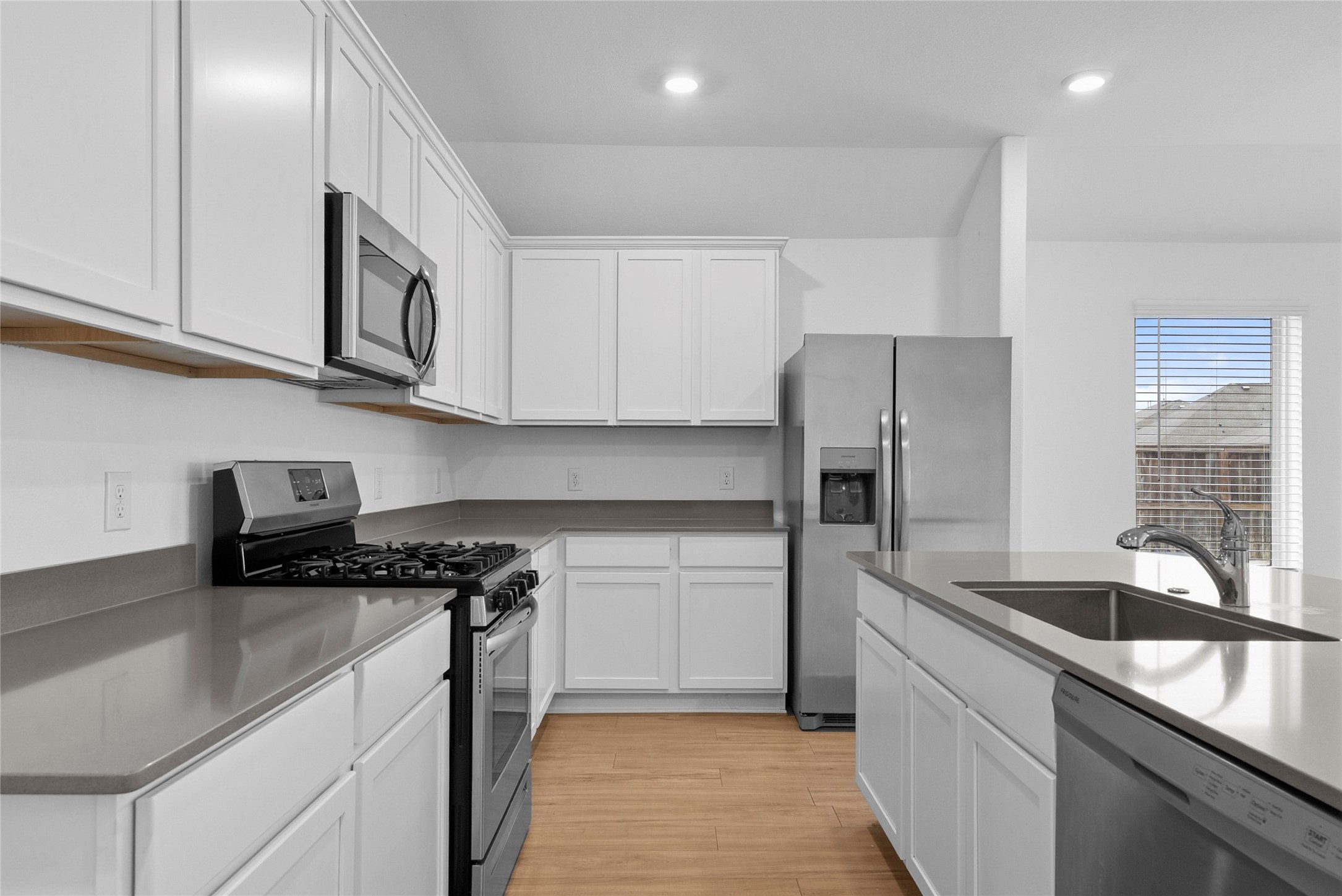 3705 Paloma Fls Lane Rosenberg, TX 77469 - Photo 7 of 27 Crisp kitchen layout with long runs of cabinetry and plenty of prep space along the counters.