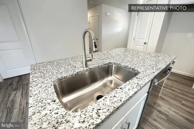 a kitchen with a sink and a refrigerator