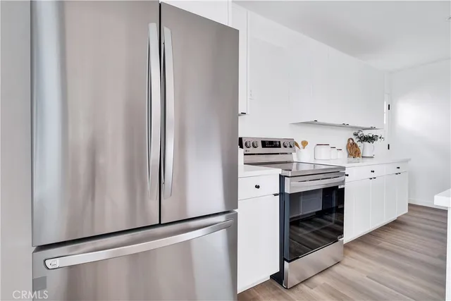 a kitchen with a refrigerator and cabinets