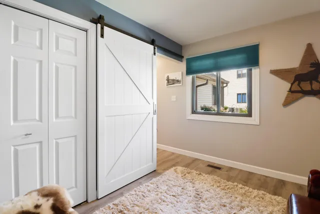 a view of room with window and wooden floor