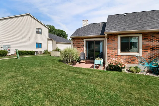 a view of a house with a yard and plants