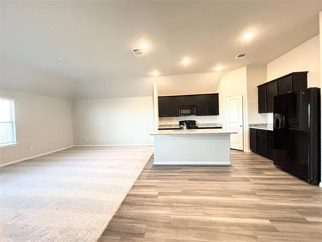 a view of a room with wooden floor and white walls
