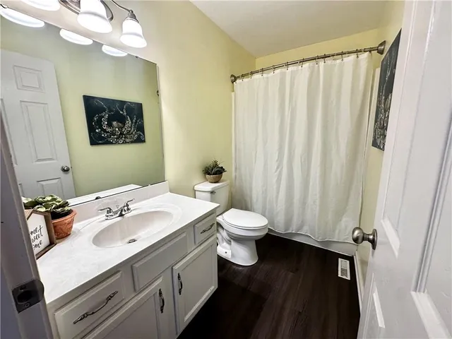 a view of walk in closet with wooden floor
