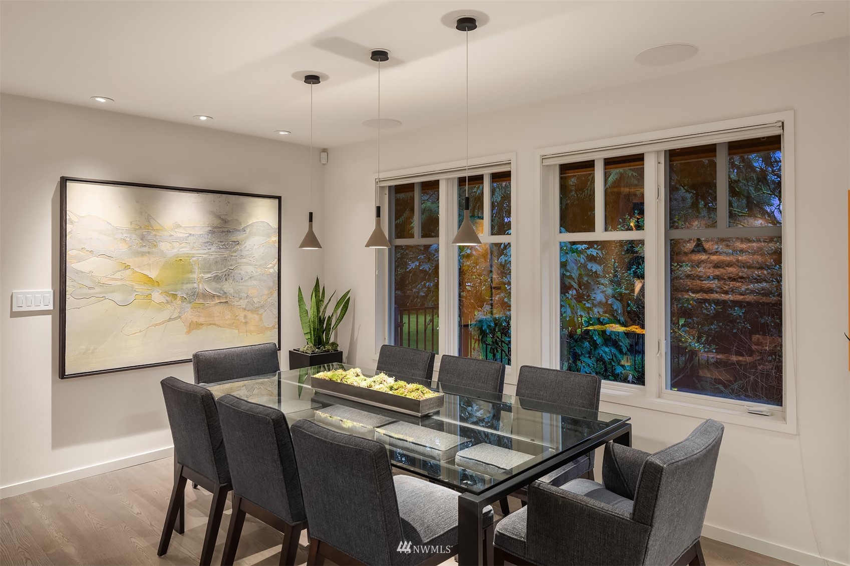 3022 Hunts Point Road Hunts Point, WA 98004 - Photo 13 of 37 a view of a dining room with furniture large windows and wooden floor