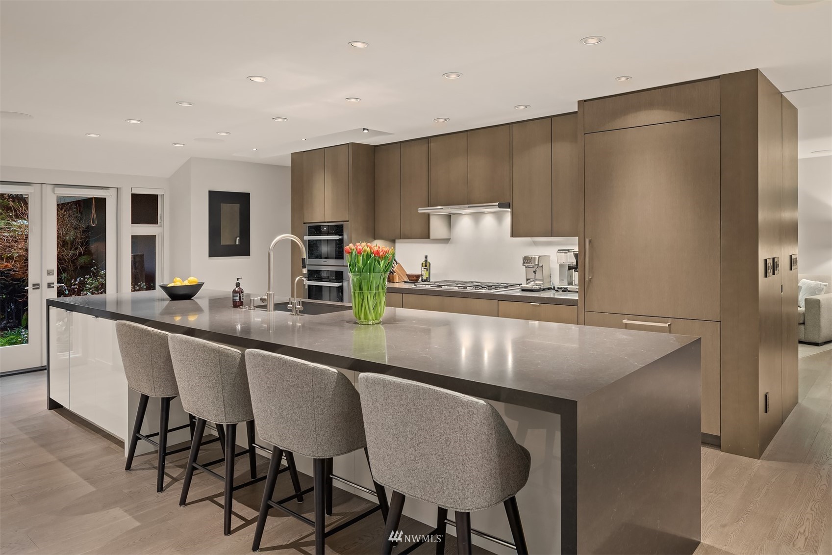 3022 Hunts Point Road Hunts Point, WA 98004 - Photo 4 of 37 a kitchen with stainless steel appliances a table chairs refrigerator and cabinets