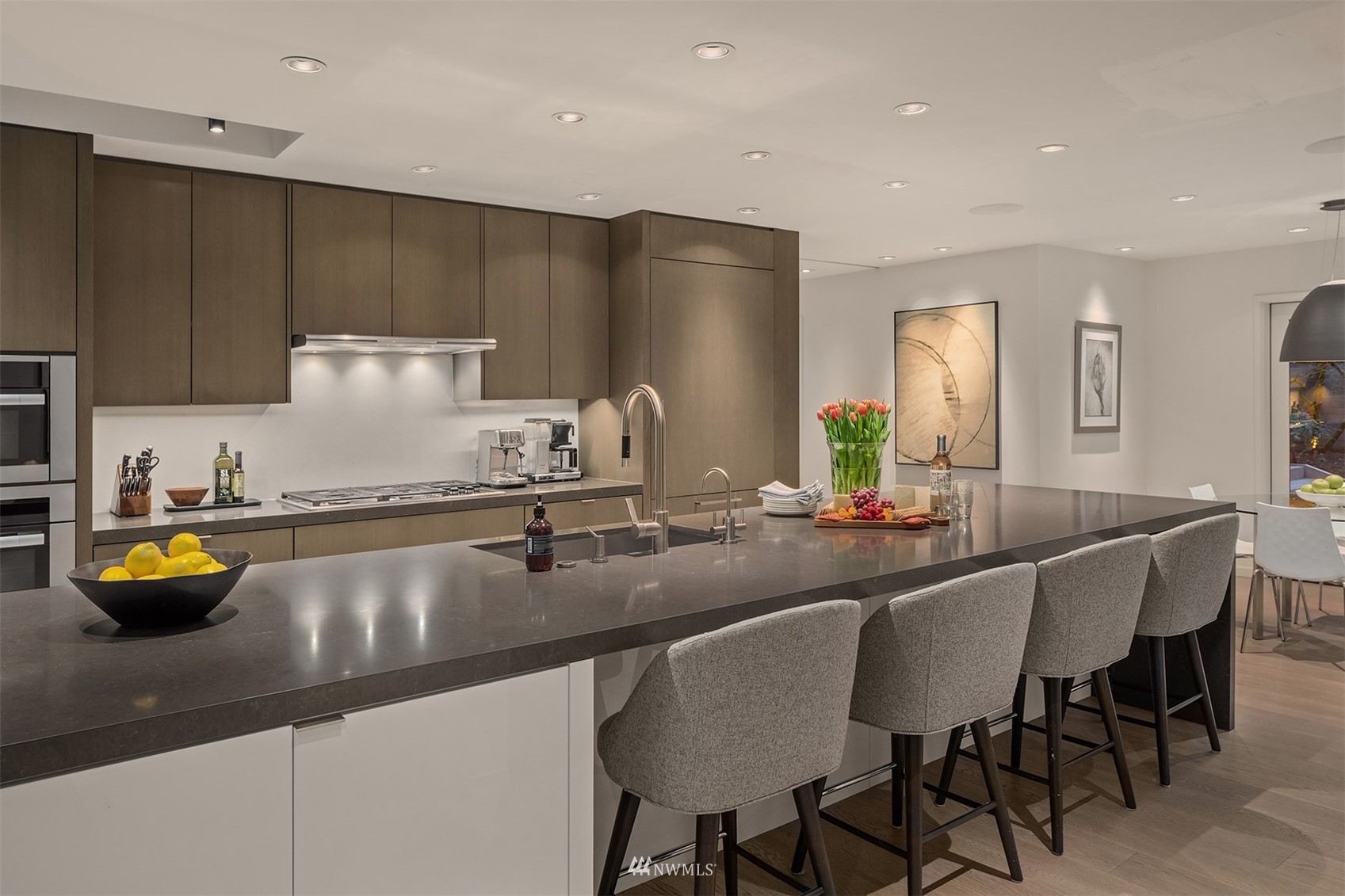 3022 Hunts Point Road Hunts Point, WA 98004 - Photo 5 of 37 a kitchen with a sink a counter and chairs