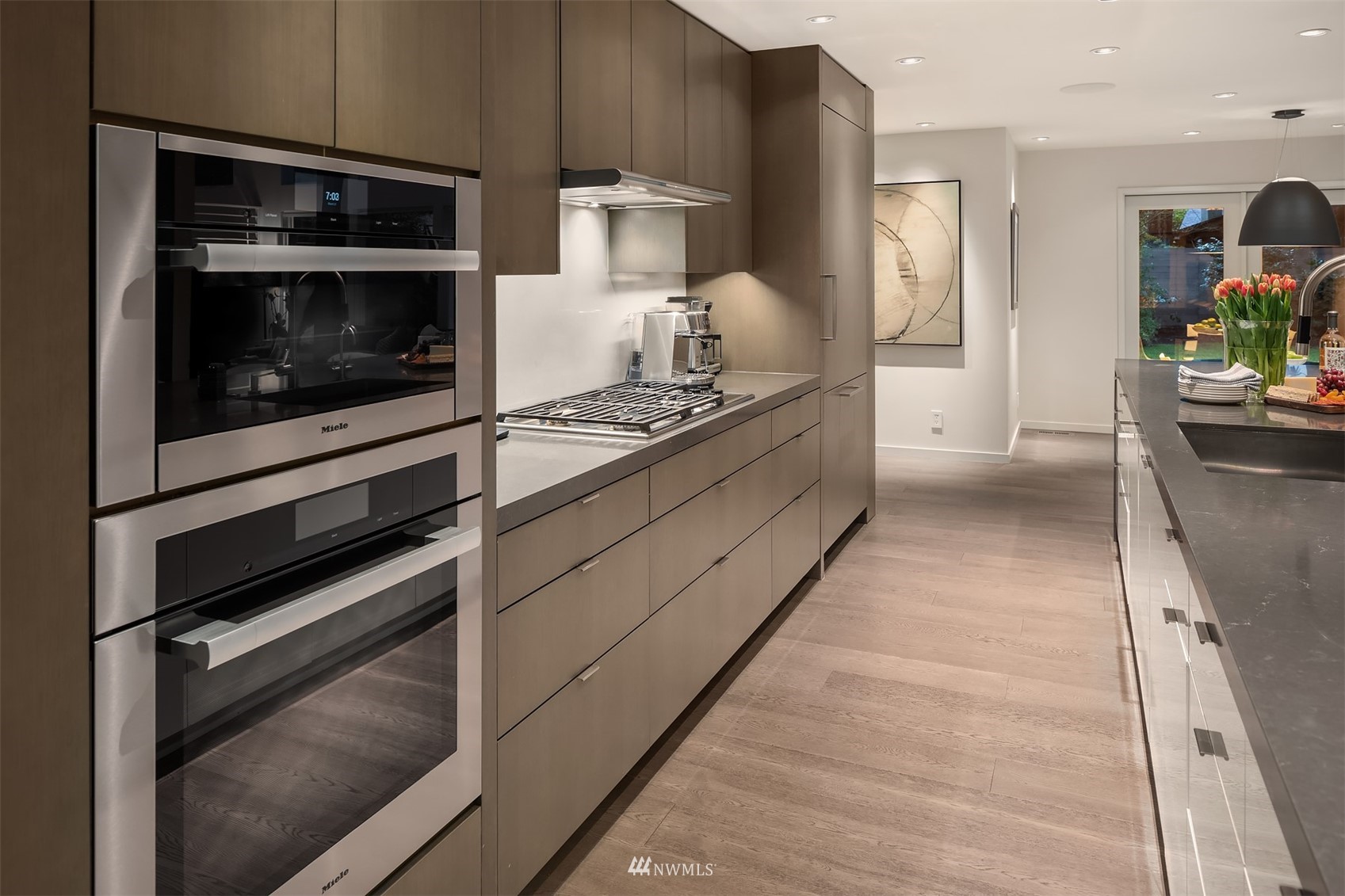 3022 Hunts Point Road Hunts Point, WA 98004 - Photo 6 of 37 a kitchen with stainless steel appliances kitchen island wooden cabinets and stove