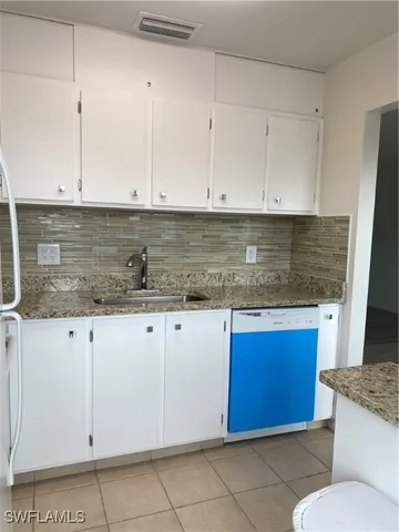 a kitchen with granite countertop granite top and white stainless steel appliances